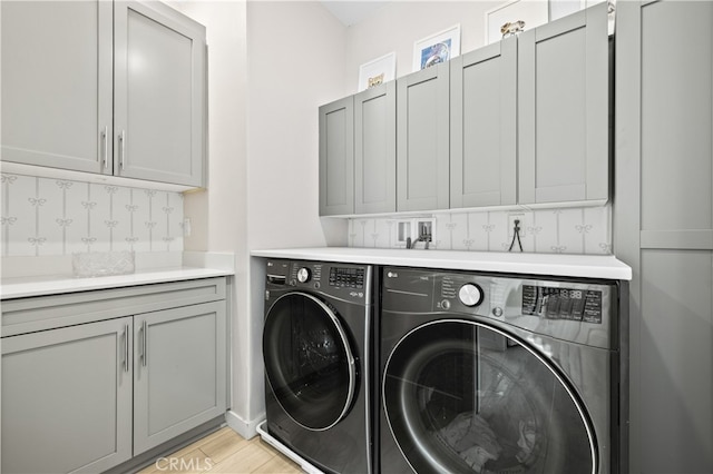 27774 Marquee Dr, Valencia, CA 91381 - laundry area featuring separate washer and dryer, cabinet space, and light wood finished floors