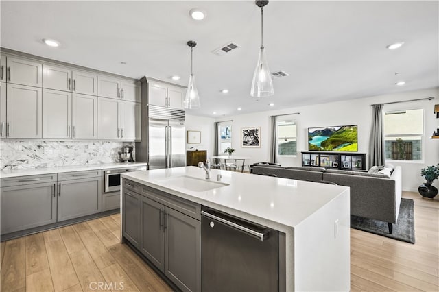 27774 Marquee Dr, Valencia, CA 91381 - kitchen with stainless steel built in fridge, gray cabinetry, dishwasher, light countertops, and light wood finished floors