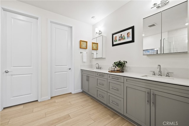 27774 Marquee Dr, Valencia, CA 91381 - full bath featuring double vanity, wood finished floors, and a shower