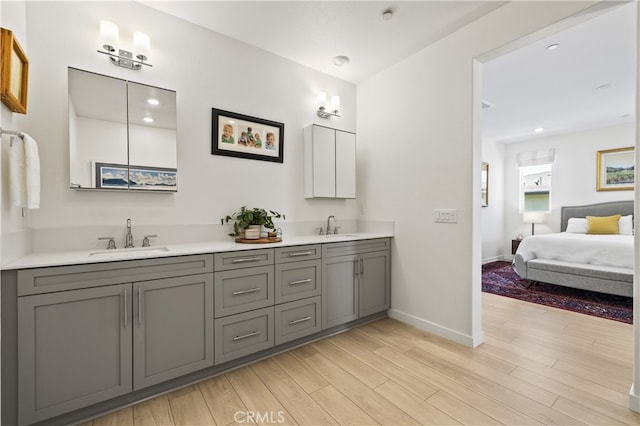 27774 Marquee Dr, Valencia, CA 91381 - ensuite bathroom with double vanity, wood finished floors, and recessed lighting