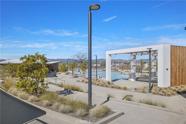 27774 Marquee Dr, Valencia, CA 91381 - view of community featuring a swimming pool, a mountain view, and a patio area