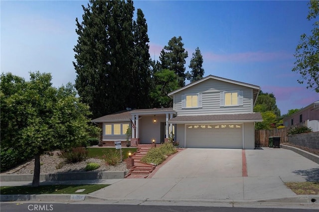 23509 Community St, West Hills, CA 91304 - tri-level home featuring driveway and an attached garage