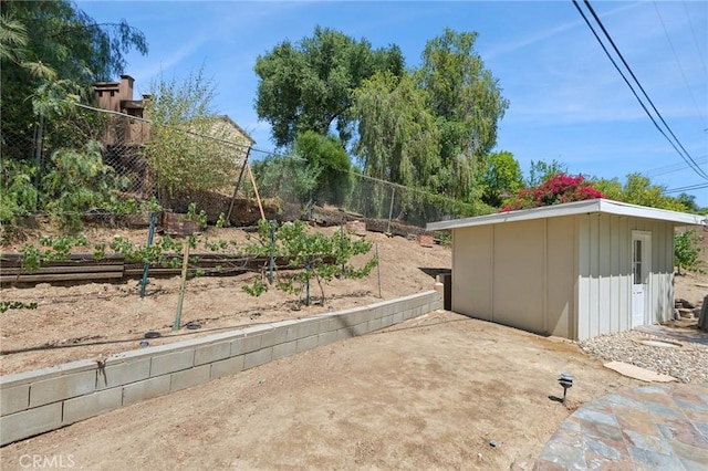 23509 Community St, West Hills, CA 91304 - view of yard with a vegetable garden, a patio area, and a shed