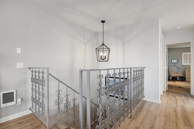 245355 Newcastle Ave, Cardiff By The Sea, CA 92007 - hallway with an upstairs landing, a chandelier, wood finished floors, and heating unit