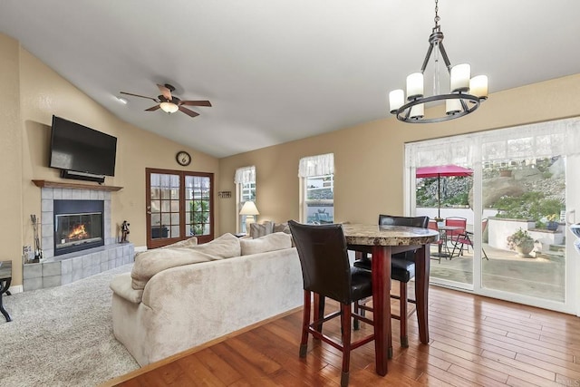 1896 Via Del Torrie, Alpine, CA 91901 - dining room featuring a chandelier, ceiling fan, vaulted ceiling, a tiled fireplace, and wood finished floors