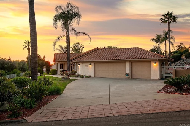1896 Via Del Torrie, Alpine, CA 91901 - mediterranean / spanish-style home with an attached garage, stucco siding, a tile roof, and driveway
