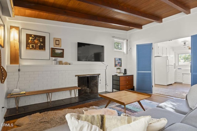 406 Santa Ana St, Ojai, CA 93023 - living area featuring wood finished floors, a brick fireplace, and a wooden ceiling with exposed beams