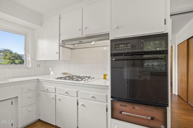 406 Santa Ana St, Ojai, CA 93023 - kitchen featuring oven, white gas stovetop, a warming drawer, backsplash, and white cabinetry