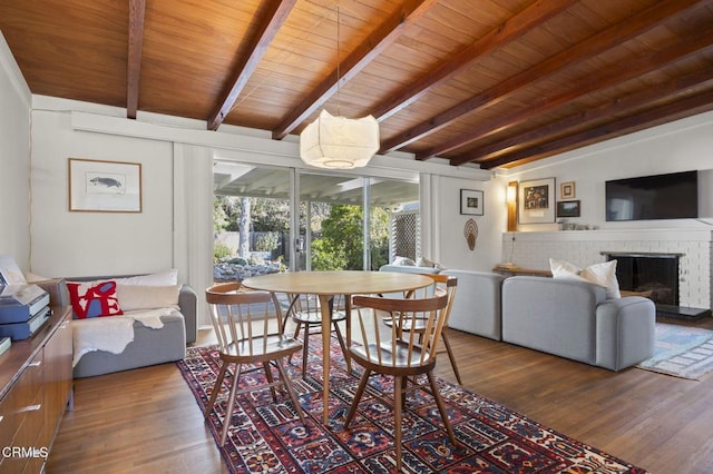 406 Santa Ana St, Ojai, CA 93023 - dining space featuring wood finished floors, a wooden ceiling with exposed beams, and a fireplace