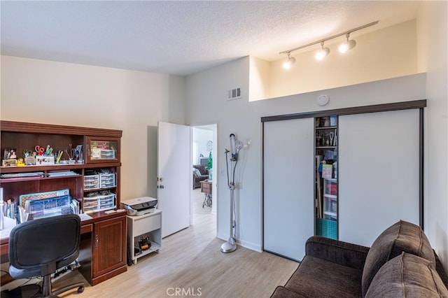 28331 Seco Canyon Rd Unit 119, Saugus, CA 91390 - home office with light wood finished floors, track lighting, and a textured ceiling