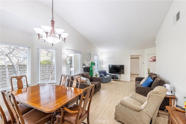 28331 Seco Canyon Rd Unit 119, Saugus, CA 91390 - dining room featuring lofted ceiling, a chandelier, and light wood-style floors