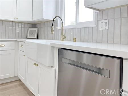 109 S San Antonio Ave, Upland, CA 91786 - kitchen with stainless steel dishwasher, light countertops, white cabinets, backsplash, and light wood-style flooring
