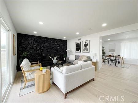 109 S San Antonio Ave, Upland, CA 91786 - living area featuring recessed lighting, a stone fireplace, and wood finished floors