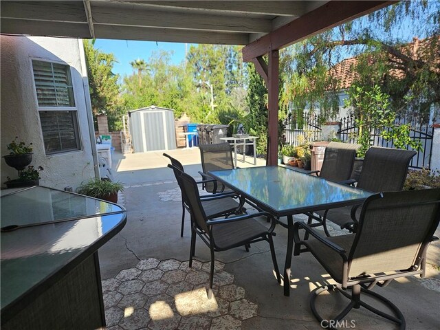 14001 Rabbit Rd, Sylmar, CA 91342 - view of patio with outdoor dining space and a shed