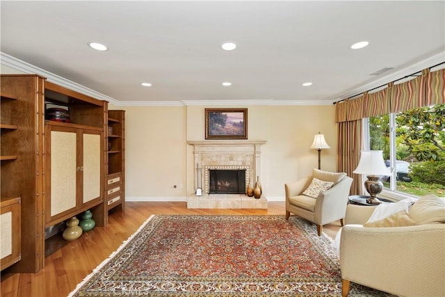 129 Five Crowns Way, Encinitas, CA 92024 - living room with crown molding, light wood-style floors, a tiled fireplace, and recessed lighting