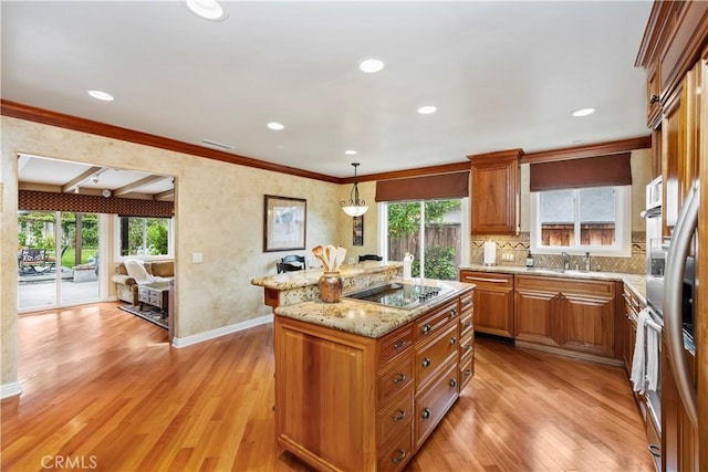 129 Five Crowns Way, Encinitas, CA 92024 - kitchen with black electric cooktop, a center island, plenty of natural light, light stone countertops, and recessed lighting