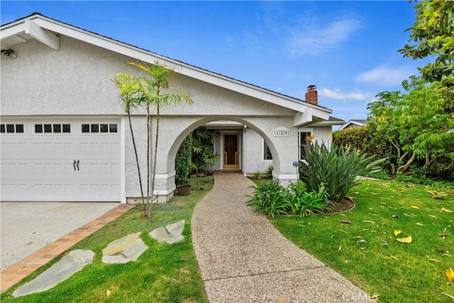 129 Five Crowns Way, Encinitas, CA 92024 - view of front of house with stucco siding, a garage, a front yard, and a chimney