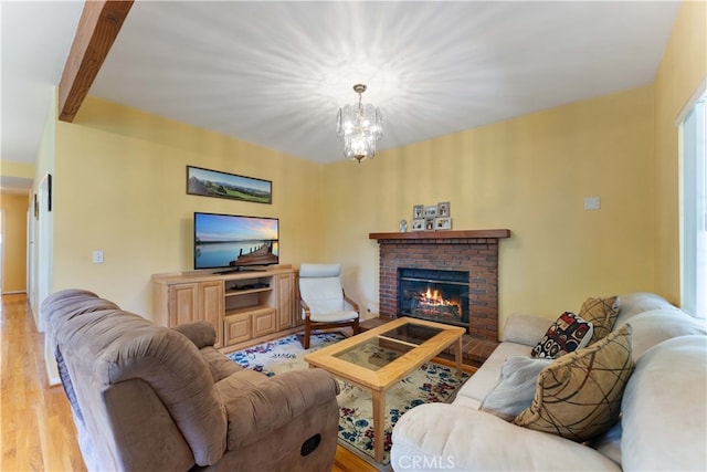 2364 6th St, La Verne, CA 91750 - living room with a fireplace, light wood-style flooring, and a chandelier