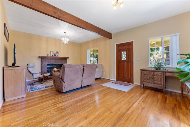 2364 6th St, La Verne, CA 91750 - living area with light wood-style flooring, a chandelier, beam ceiling, and a brick fireplace