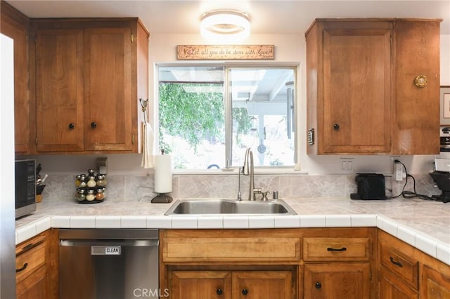 5295 Bronson Way, Riverside, CA 92506 - kitchen featuring stainless steel dishwasher, brown cabinetry, and light countertops