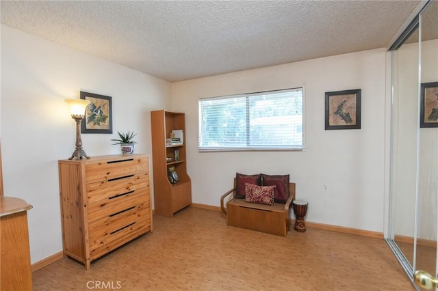 5295 Bronson Way, Riverside, CA 92506 - living area featuring a textured ceiling and light floors