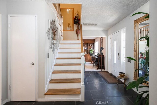 5295 Bronson Way, Riverside, CA 92506 - foyer entrance featuring stairs and a textured ceiling