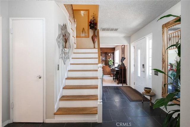 5295 Bronson Way, Riverside, CA 92506 - entrance foyer featuring stairway and a textured ceiling