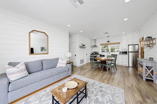 2103 Loquat Pl, Oceanside, CA 92054 - living area featuring light wood-type flooring, wooden walls, and recessed lighting
