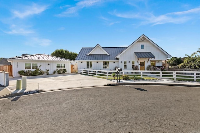 2103 Loquat Pl, Oceanside, CA 92054 - modern farmhouse with a standing seam roof, board and batten siding, a metal roof, and a fenced front yard