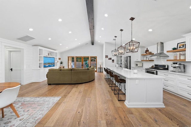 2103 Loquat Pl, Oceanside, CA 92054 - kitchen featuring wall chimney exhaust hood, open shelves, stainless steel electric range, light wood-style flooring, and a kitchen breakfast bar