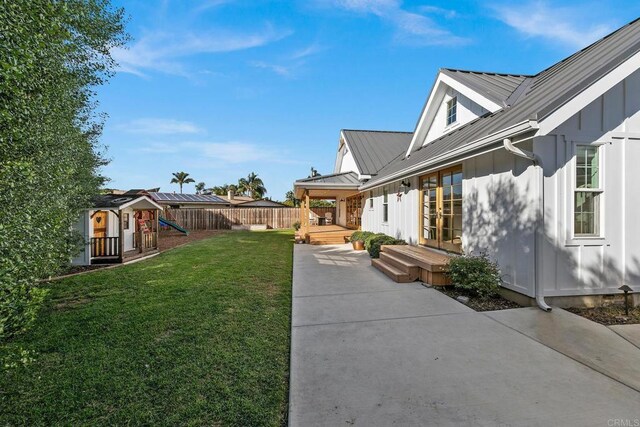 2103 Loquat Pl, Oceanside, CA 92054 - view of yard featuring a playground, a wooden deck, a patio, and french doors
