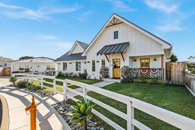 2103 Loquat Pl, Oceanside, CA 92054 - modern farmhouse featuring board and batten siding, a standing seam roof, a fenced front yard, and a metal roof