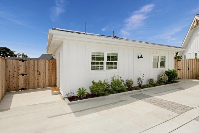 2103 Loquat Pl, Oceanside, CA 92054 - view of property exterior featuring a gate, board and batten siding, and a patio area