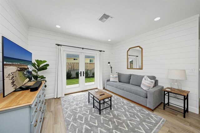 2103 Loquat Pl, Oceanside, CA 92054 - living room featuring french doors, wooden walls, light wood-style floors, and recessed lighting