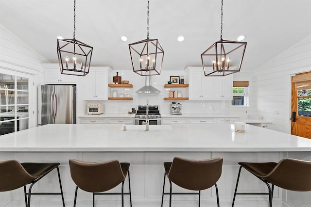 2103 Loquat Pl, Oceanside, CA 92054 - kitchen with appliances with stainless steel finishes, vaulted ceiling, open shelves, a chandelier, and decorative backsplash