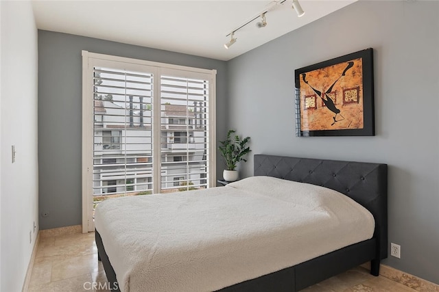 13331 Moorpark St Unit 316, Sherman Oaks, CA 91423 - bedroom featuring baseboards and rail lighting