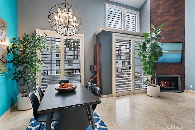 13331 Moorpark St Unit 316, Sherman Oaks, CA 91423 - dining space featuring a chandelier and a lit fireplace