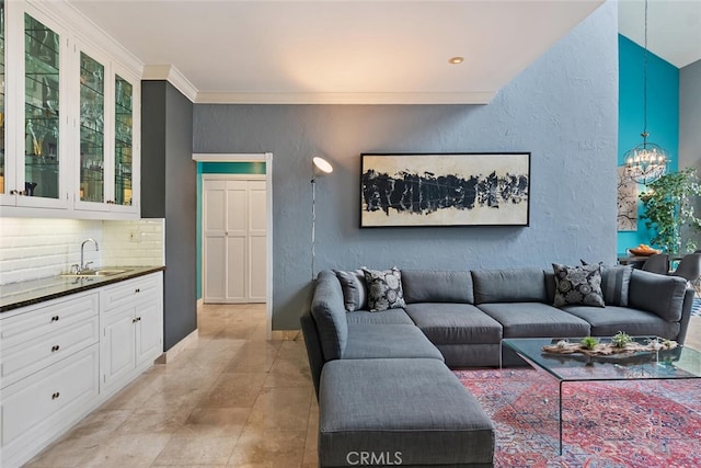 13331 Moorpark St Unit 316, Sherman Oaks, CA 91423 - living room featuring a chandelier, a textured wall, and ornamental molding