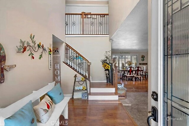13520 Preciado Ave, Chino, CA 91710 - entryway with a high ceiling, wood finished floors, and stairway