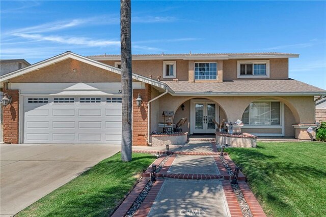 13520 Preciado Ave, Chino, CA 91710 - traditional-style house with french doors, stucco siding, a garage, driveway, and a front yard