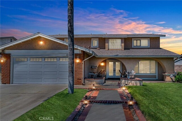 13520 Preciado Ave, Chino, CA 91710 - traditional-style home featuring french doors, stucco siding, driveway, a garage, and a yard