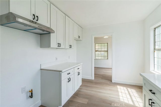 717 La Porte Ave, San Bernardino, CA 92405 - kitchen featuring under cabinet range hood, light countertops, and plenty of natural light