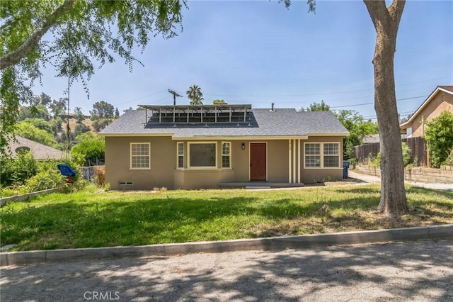 717 La Porte Ave, San Bernardino, CA 92405 - bungalow-style home with roof with shingles, solar panels, and stucco siding