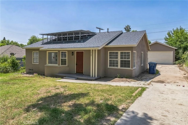 717 La Porte Ave, San Bernardino, CA 92405 - view of front of property featuring roof with shingles, stucco siding, an outdoor structure, and a front lawn