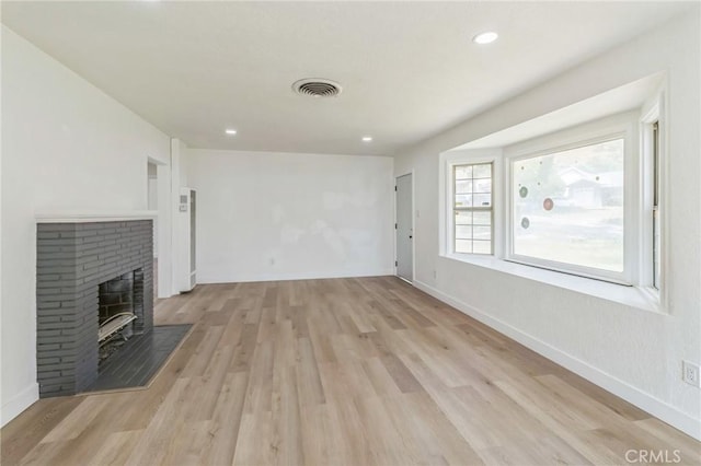 717 La Porte Ave, San Bernardino, CA 92405 - unfurnished living room featuring light wood finished floors, a fireplace, and recessed lighting