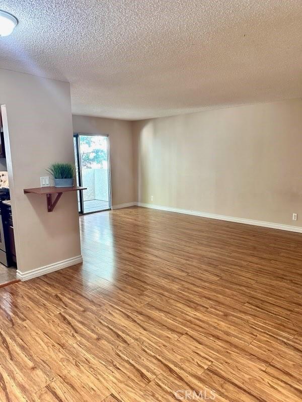 13080 Dronfield Ave Unit 80, Sylmar, CA 91342 - unfurnished room featuring light wood-type flooring and a textured ceiling