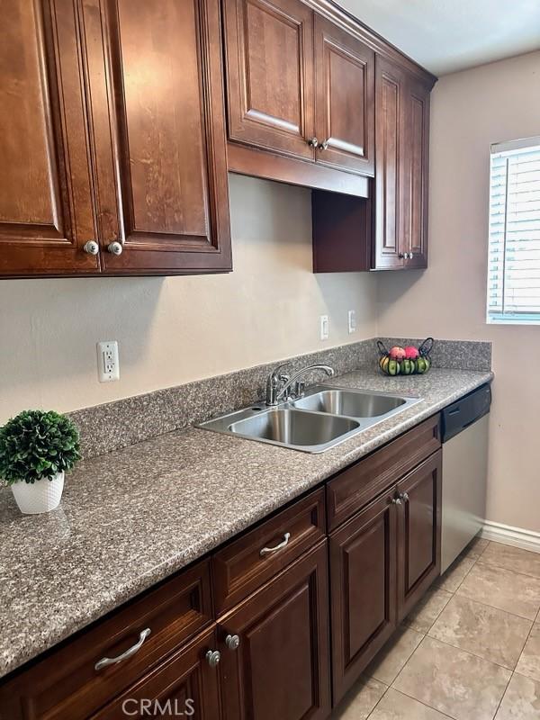 13080 Dronfield Ave Unit 80, Sylmar, CA 91342 - kitchen with stainless steel dishwasher, light tile patterned flooring, and dark brown cabinetry