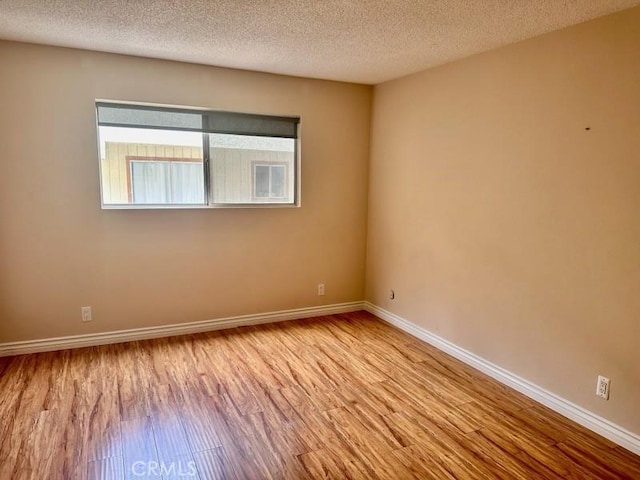13080 Dronfield Ave Unit 80, Sylmar, CA 91342 - empty room with wood finished floors and a textured ceiling