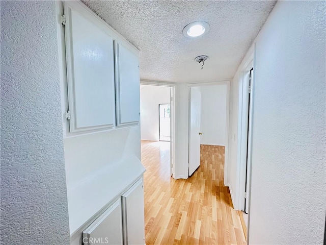 343 Park Shadow Ct, Baldwin Park, CA 91706 - corridor with a textured wall, a textured ceiling, and light wood-type flooring