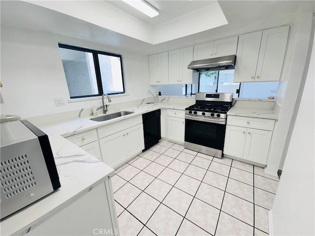 343 Park Shadow Ct, Baldwin Park, CA 91706 - kitchen with gas range, dishwasher, under cabinet range hood, a tray ceiling, and light stone countertops